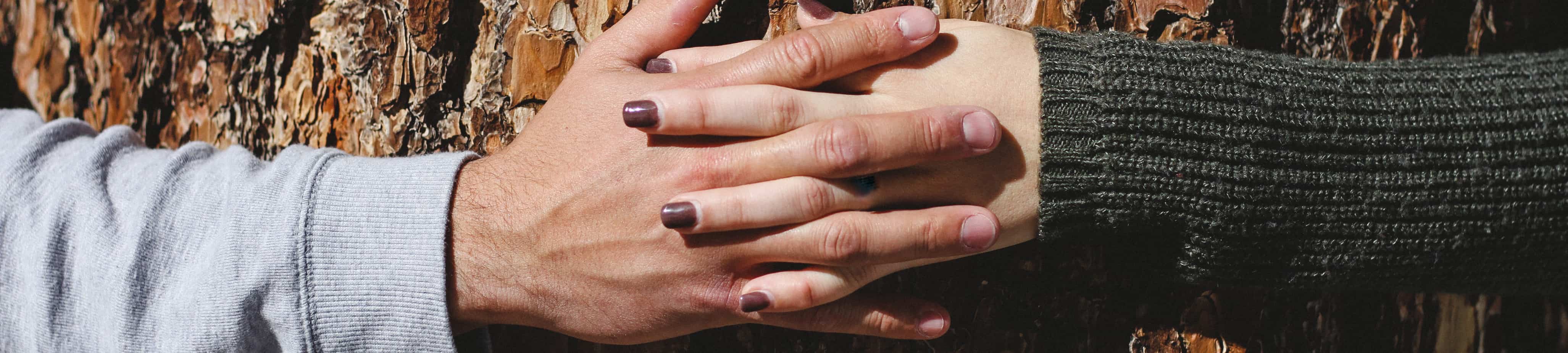 Two hands with fingers interlaced as a header for the contact page