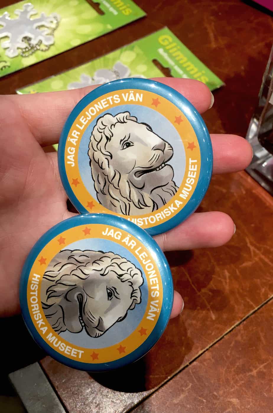 two badges with illustrated lions